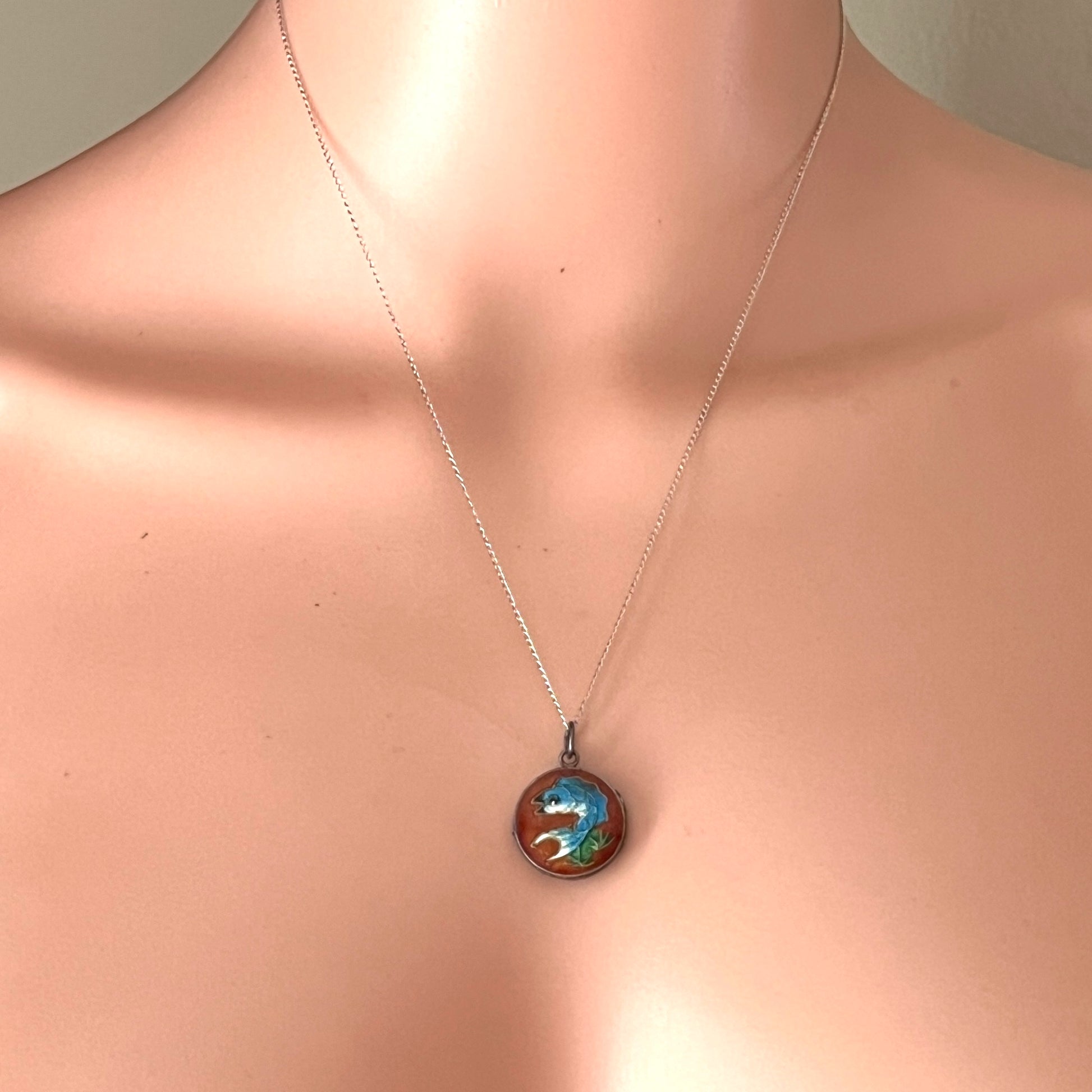 Vintage sterling silver enamel koi fish locket necklace displayed on mannequin.