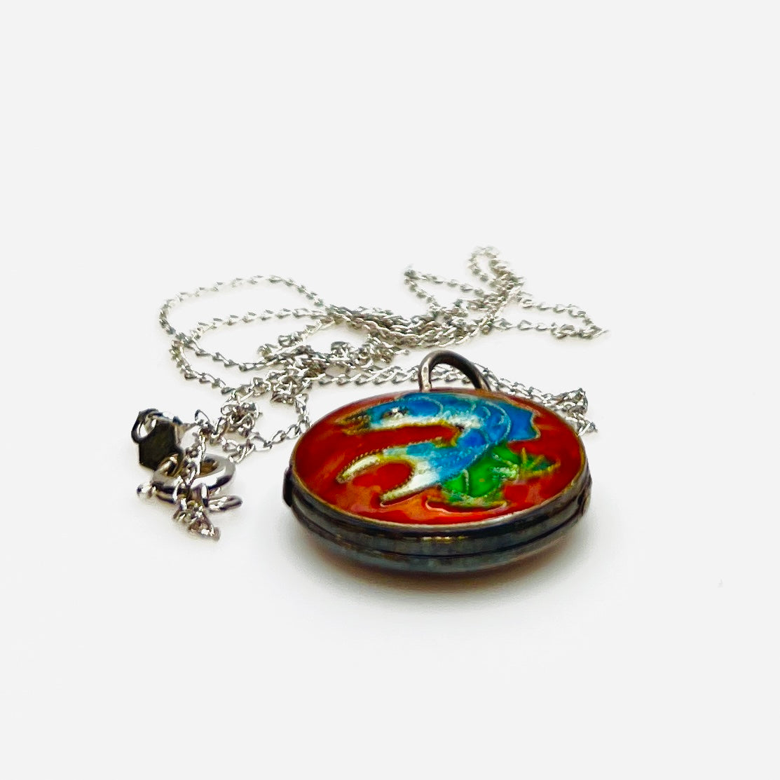 Side view of vintage sterling silver cloisonné koi fish enamel locket