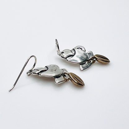 Side view of vintage silver coffee cup earrings with dimensional bean dangles