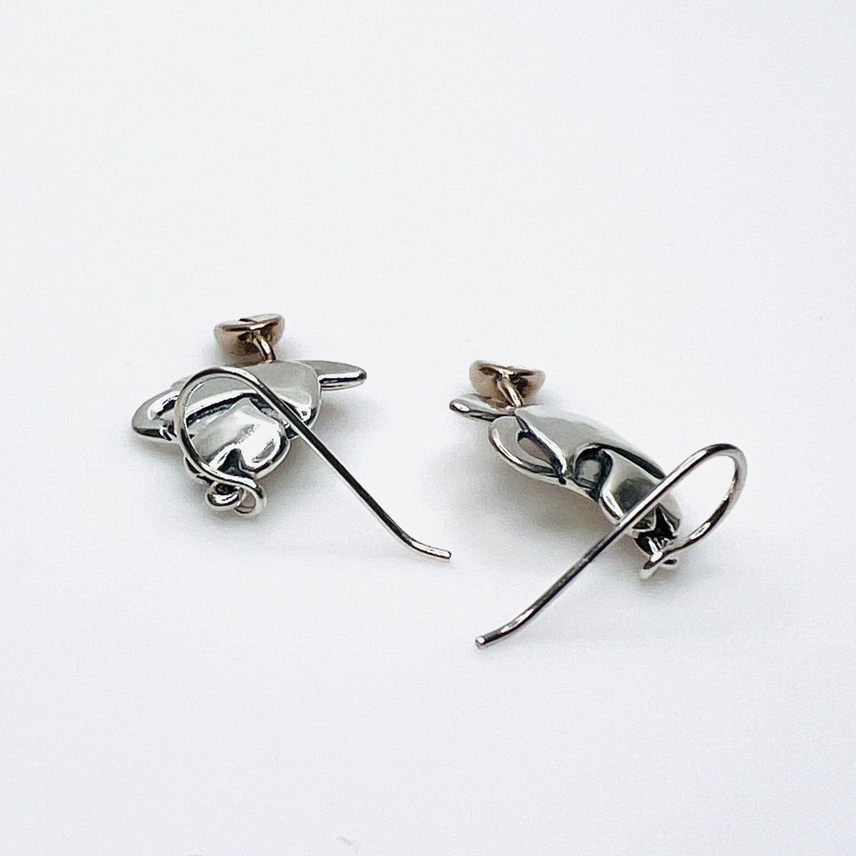 Side view of vintage silver coffee cup earrings with dimensional bean dangles