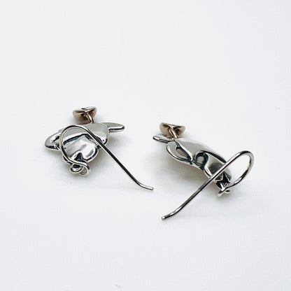 Side view of vintage silver coffee cup earrings with dimensional bean dangles