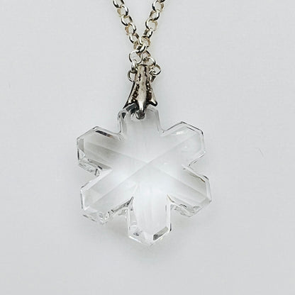 Close-up of faceted crystal snowflake pendant on silver bail