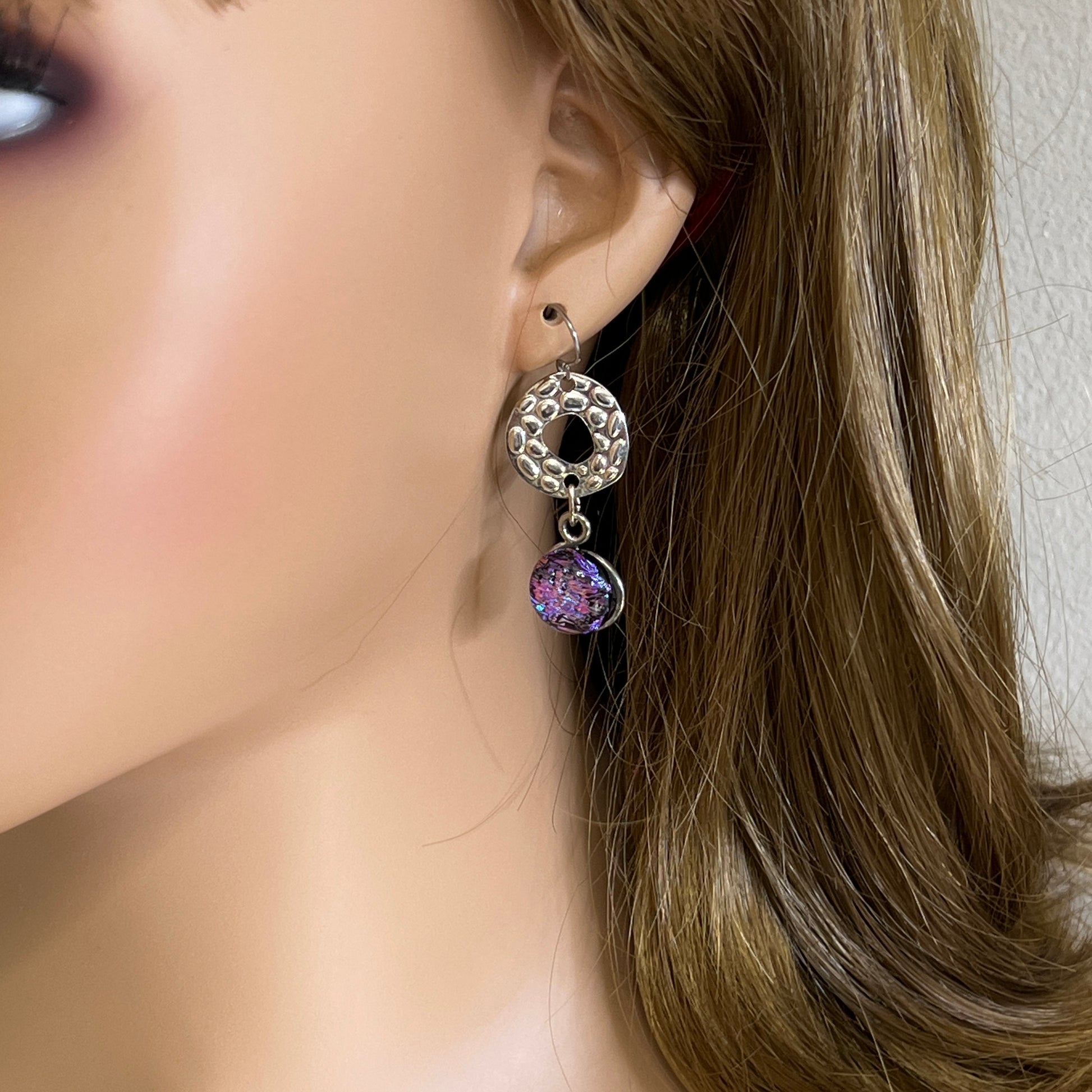 Artisan dangle earrings worn on ear
