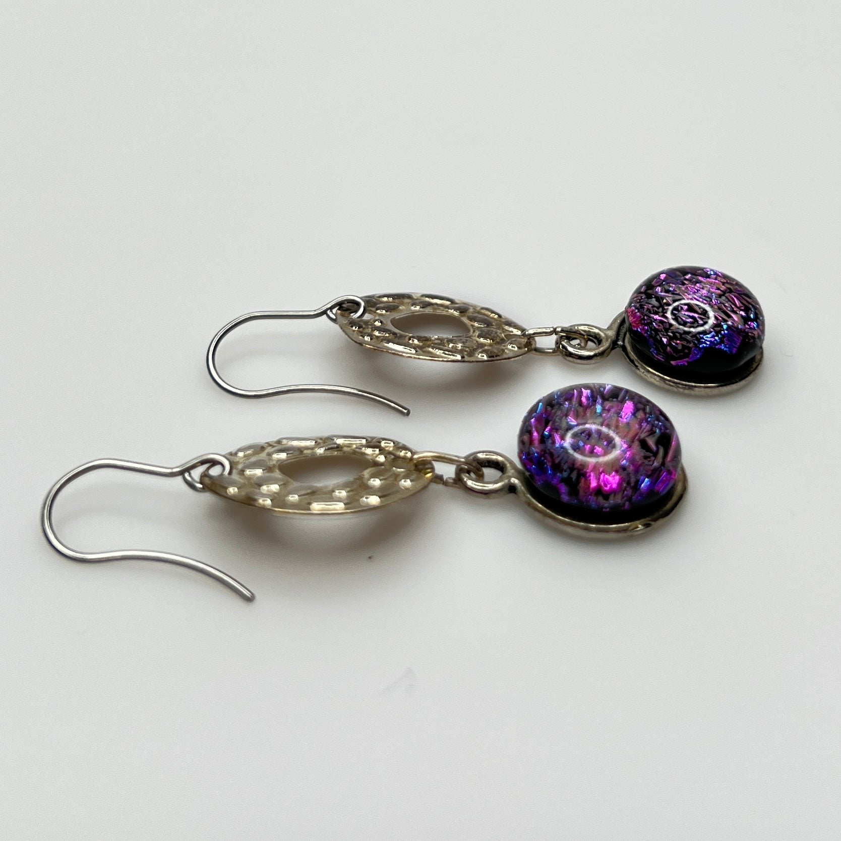 Side view showing hook ear wires and textured silver circles