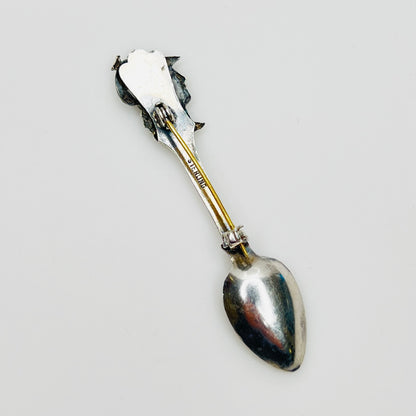 Back of sterling silver brooch showing clasp and stamp
