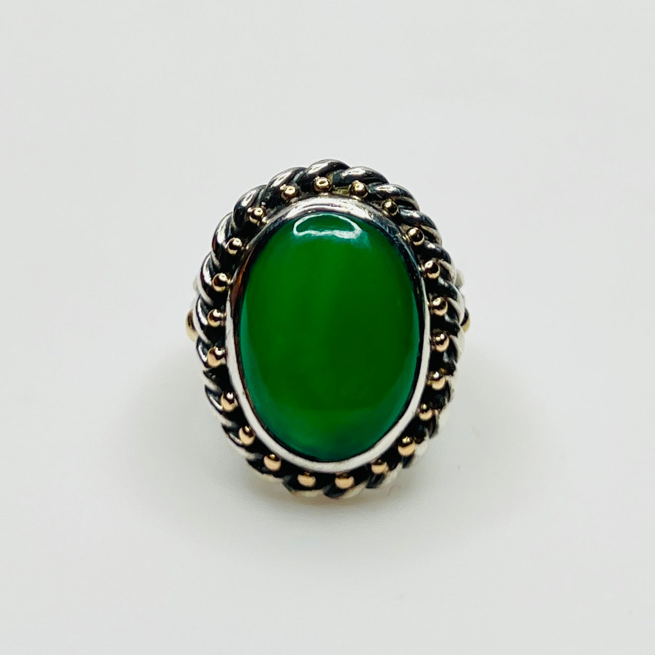 Vintage artisan sterling silver ring with oval green gemstone cabochon and rope border