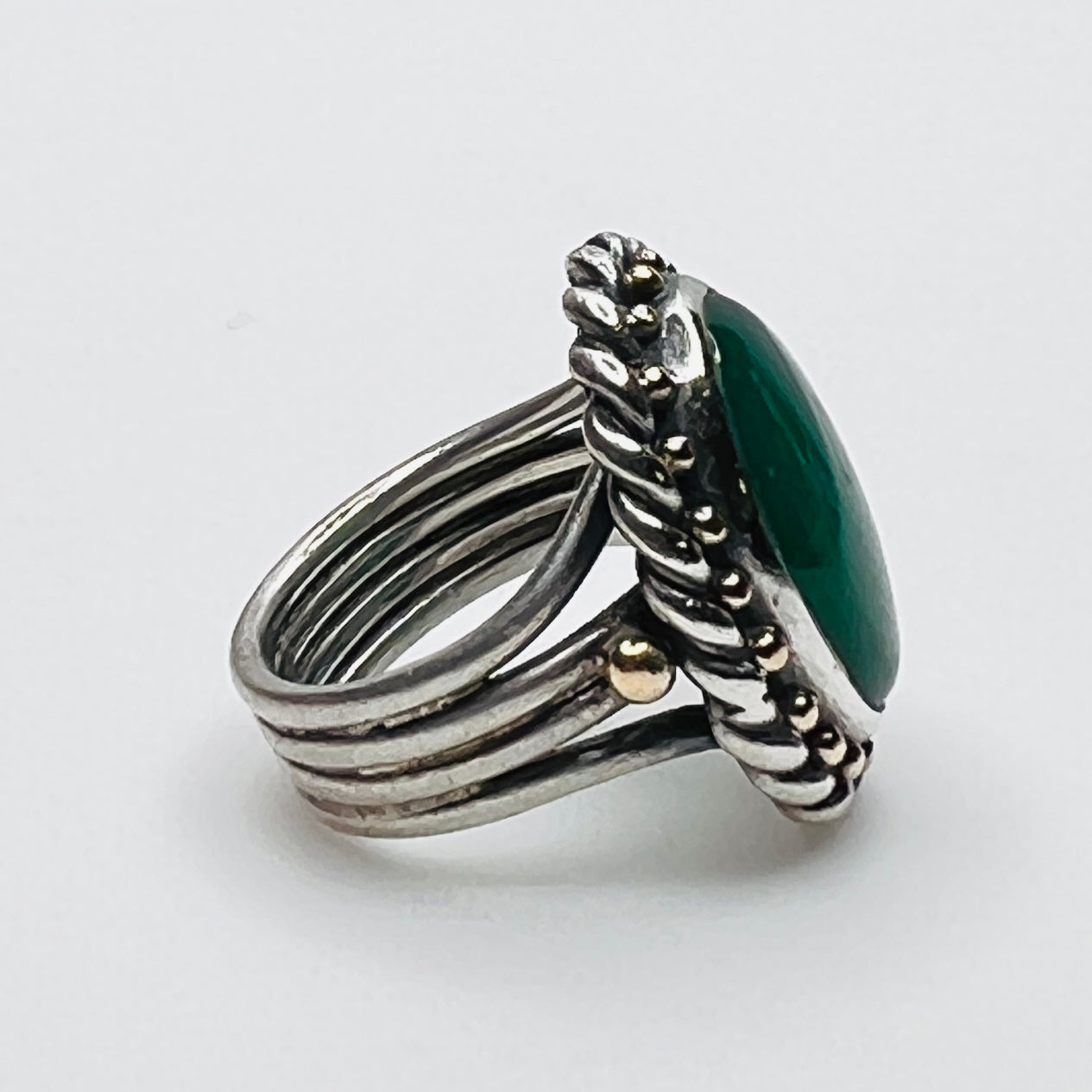 Side profile of vintage artisan sterling silver green gemstone ring