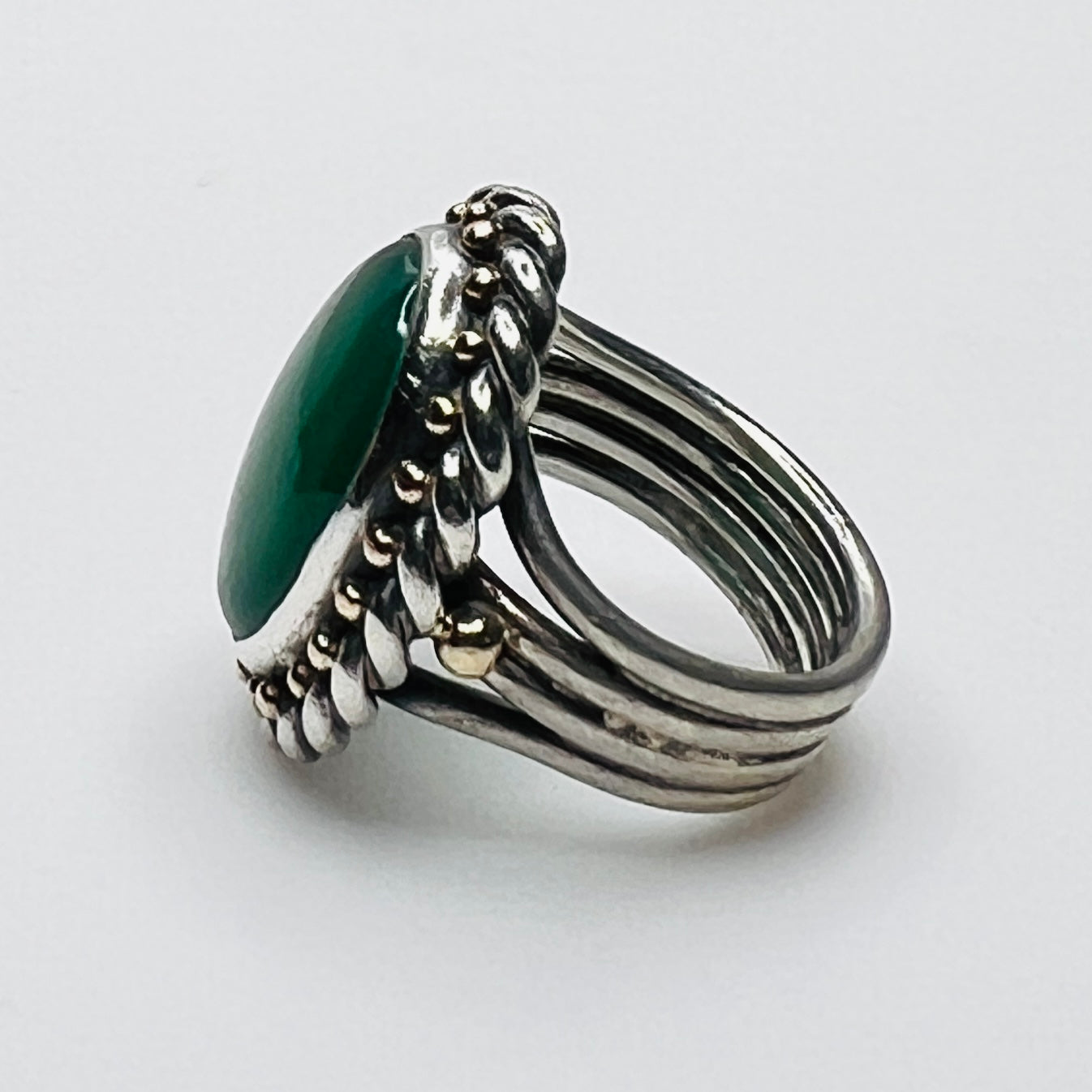 Side profile of vintage artisan sterling silver green gemstone ring