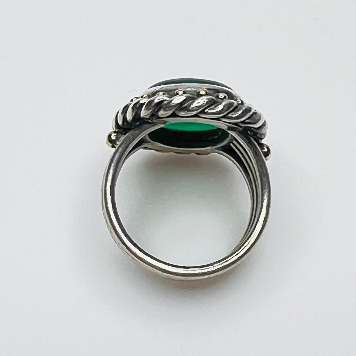 Side profile of vintage artisan sterling silver green gemstone ring