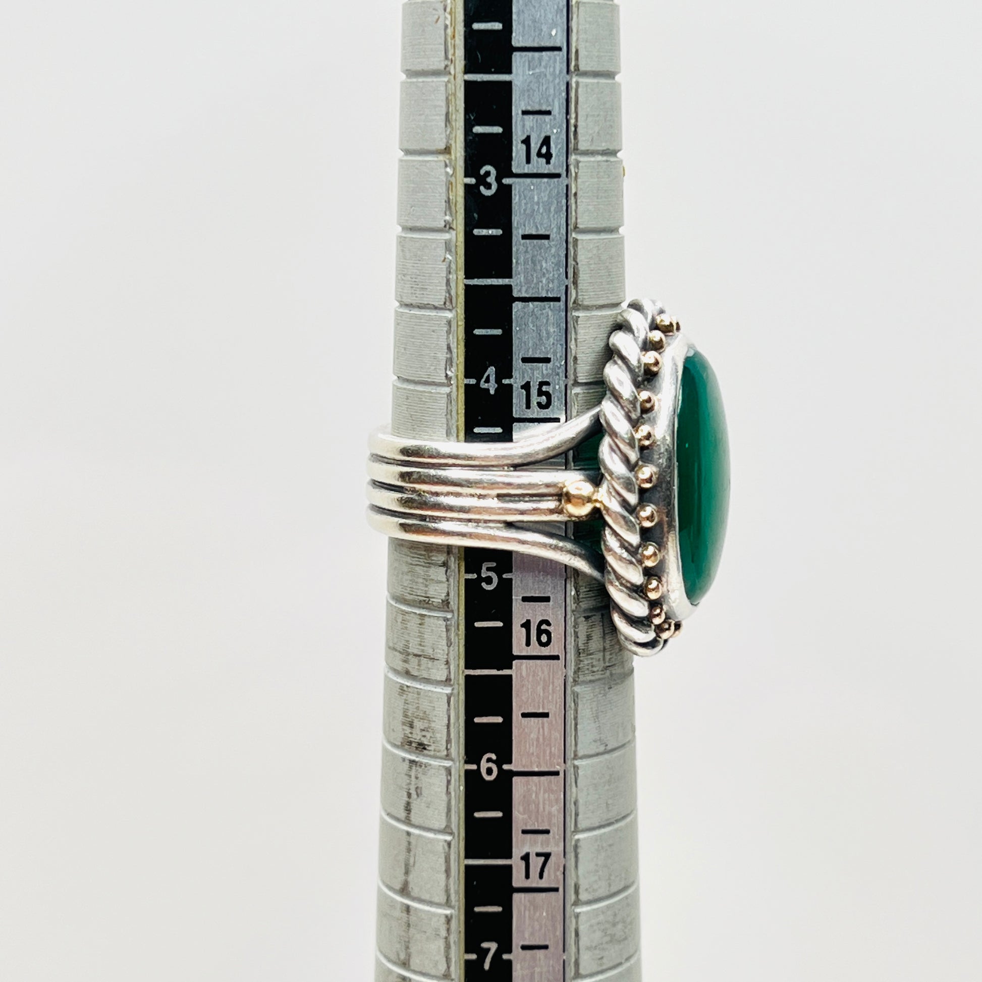 Vintage artisan sterling silver green gemstone ring shown on mandrel, size 4.75