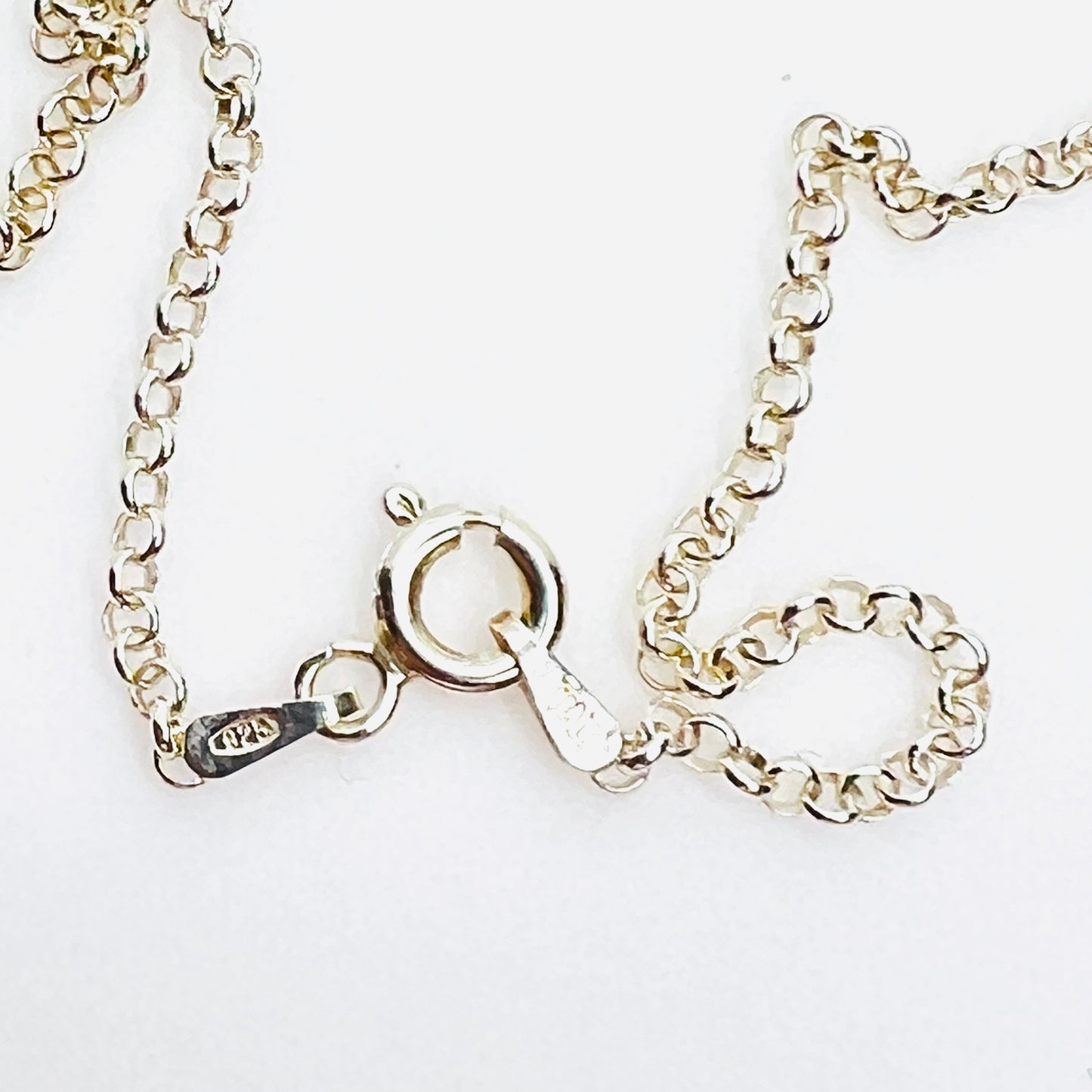 Close-up of sterling silver 925 Italy spring ring clasp on necklace.