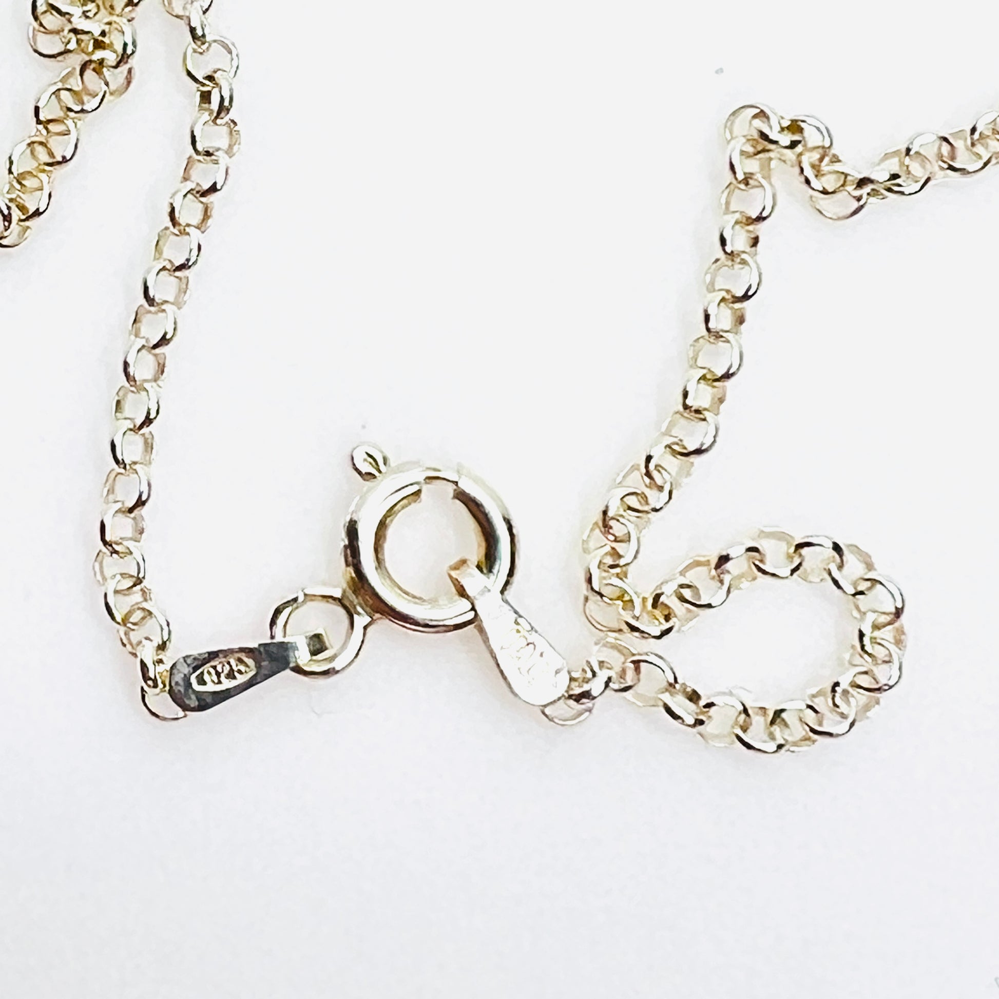 Close-up of sterling silver 925 Italy spring ring clasp on necklace.