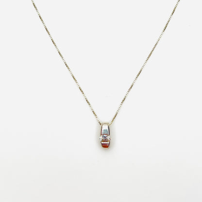 Vintage sterling silver pendant necklace with oval channel-set cubic zirconia solitaire.