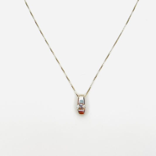 Vintage sterling silver pendant necklace with oval channel-set cubic zirconia solitaire.
