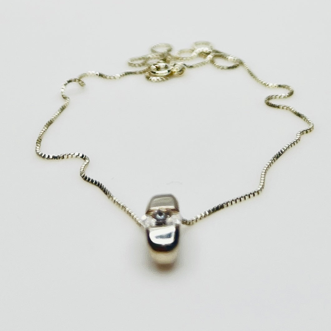 Side view of vintage sterling silver CZ pendant with Italian box chain.