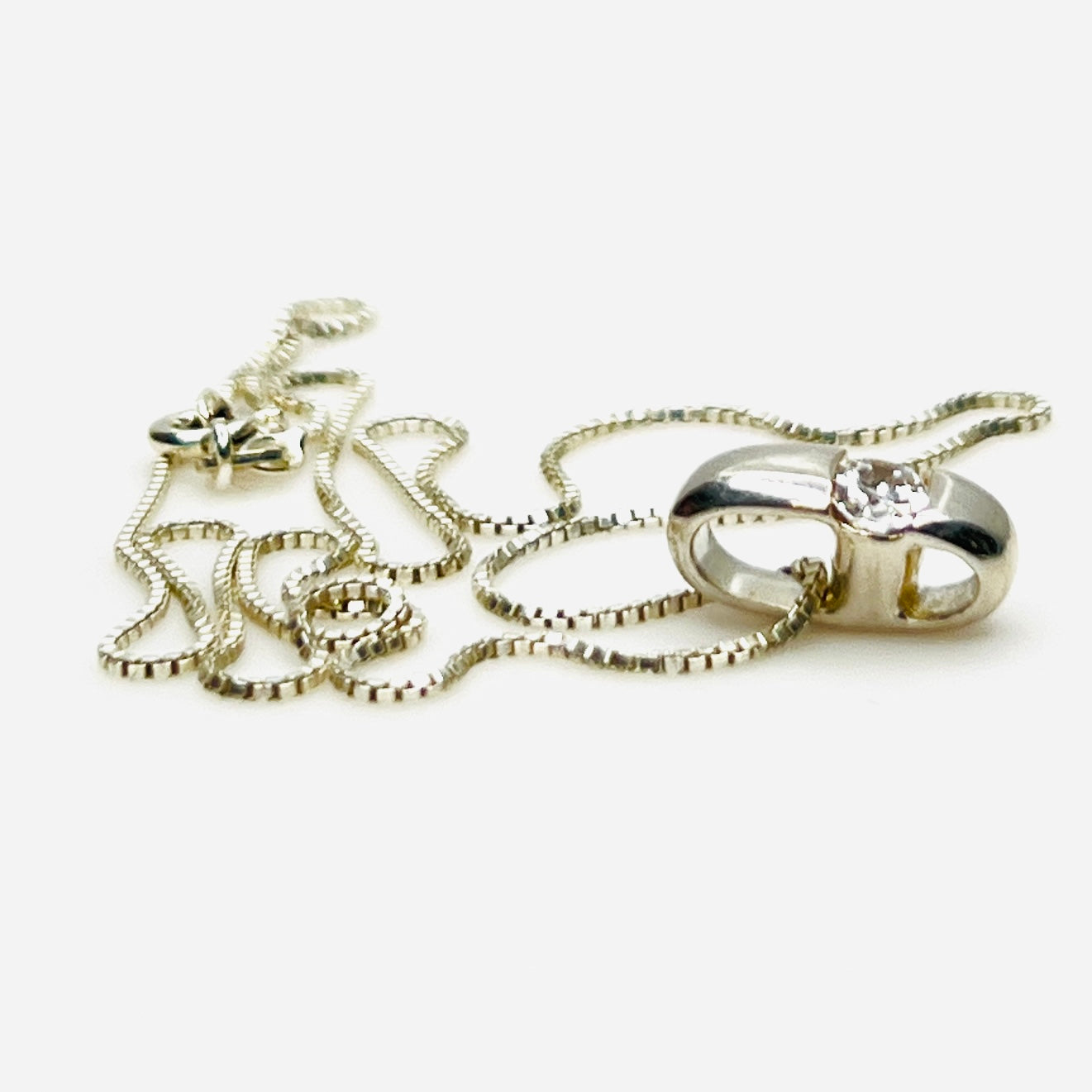 Side view of vintage sterling silver CZ pendant with Italian box chain.