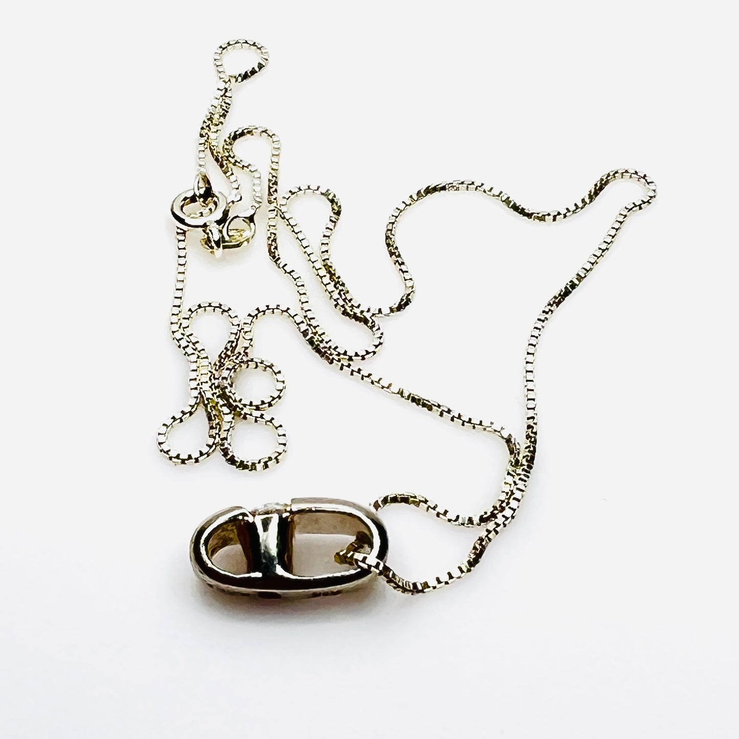 Side view of vintage sterling silver CZ pendant with Italian box chain.