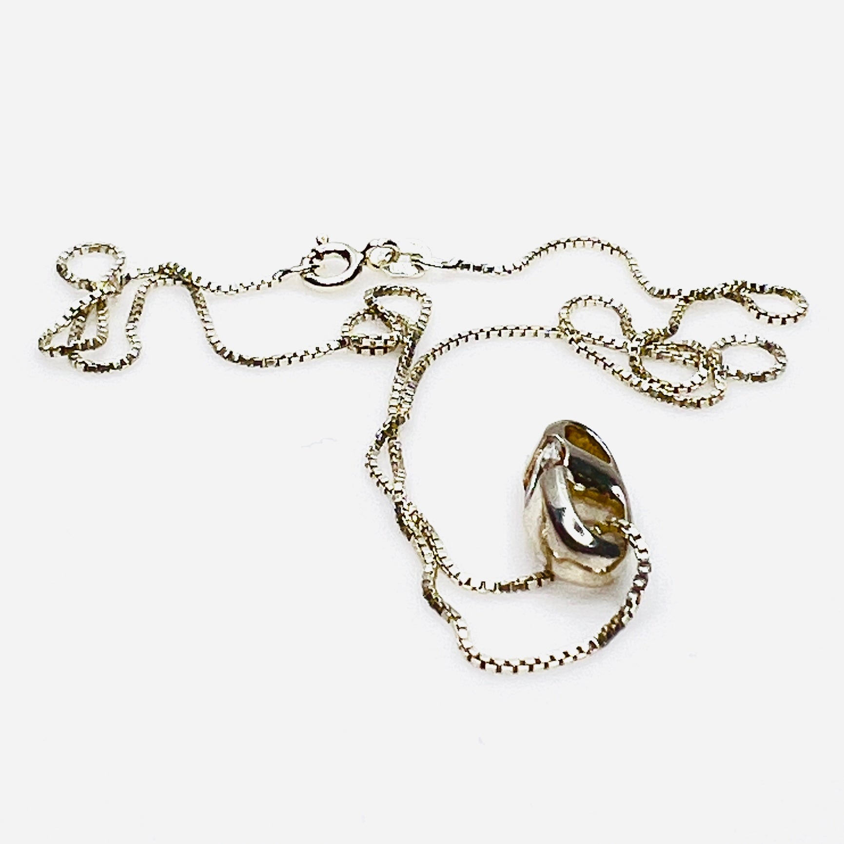 Side view of vintage sterling silver CZ pendant with Italian box chain.