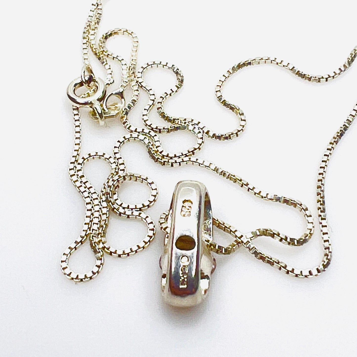 Reverse of sterling silver pendant showing CME and 925 hallmark.