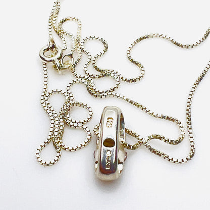 Reverse of sterling silver pendant showing CME and 925 hallmark.