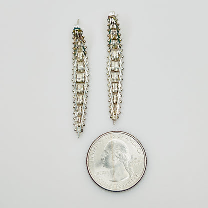 Sterling silver geometric dangle earrings beside quarter for size reference