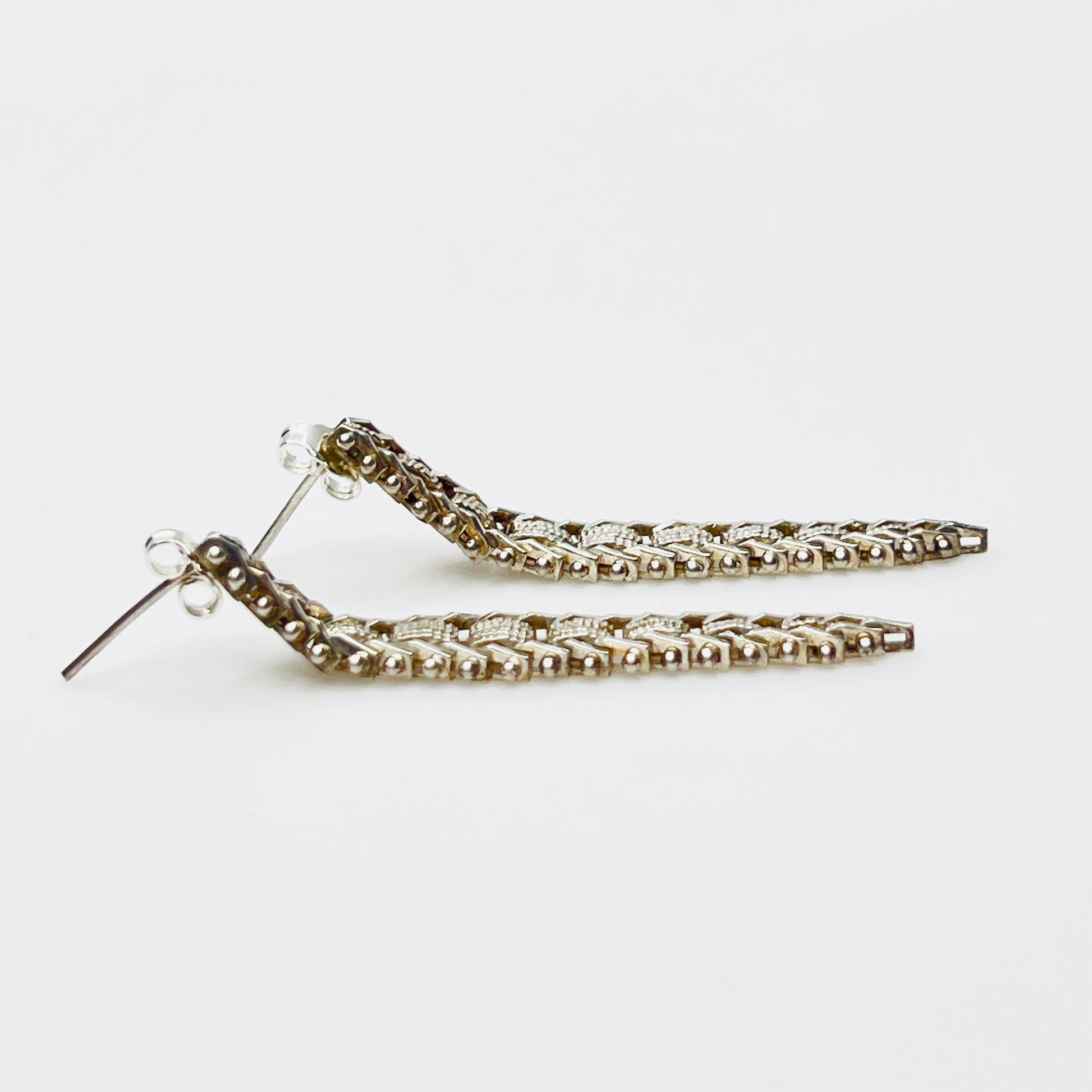 Side view of vintage sterling silver modernist pierced earrings