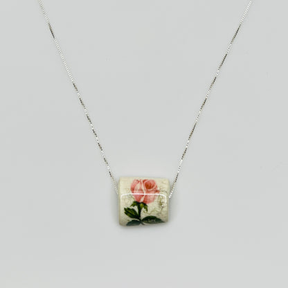 Close-up of pink rose tile pendant with crackle glaze detail