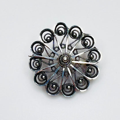 Vintage sterling silver Scandinavian filigree pinwheel rosette brooch.