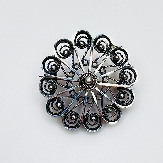 Vintage sterling silver Scandinavian filigree pinwheel rosette brooch.