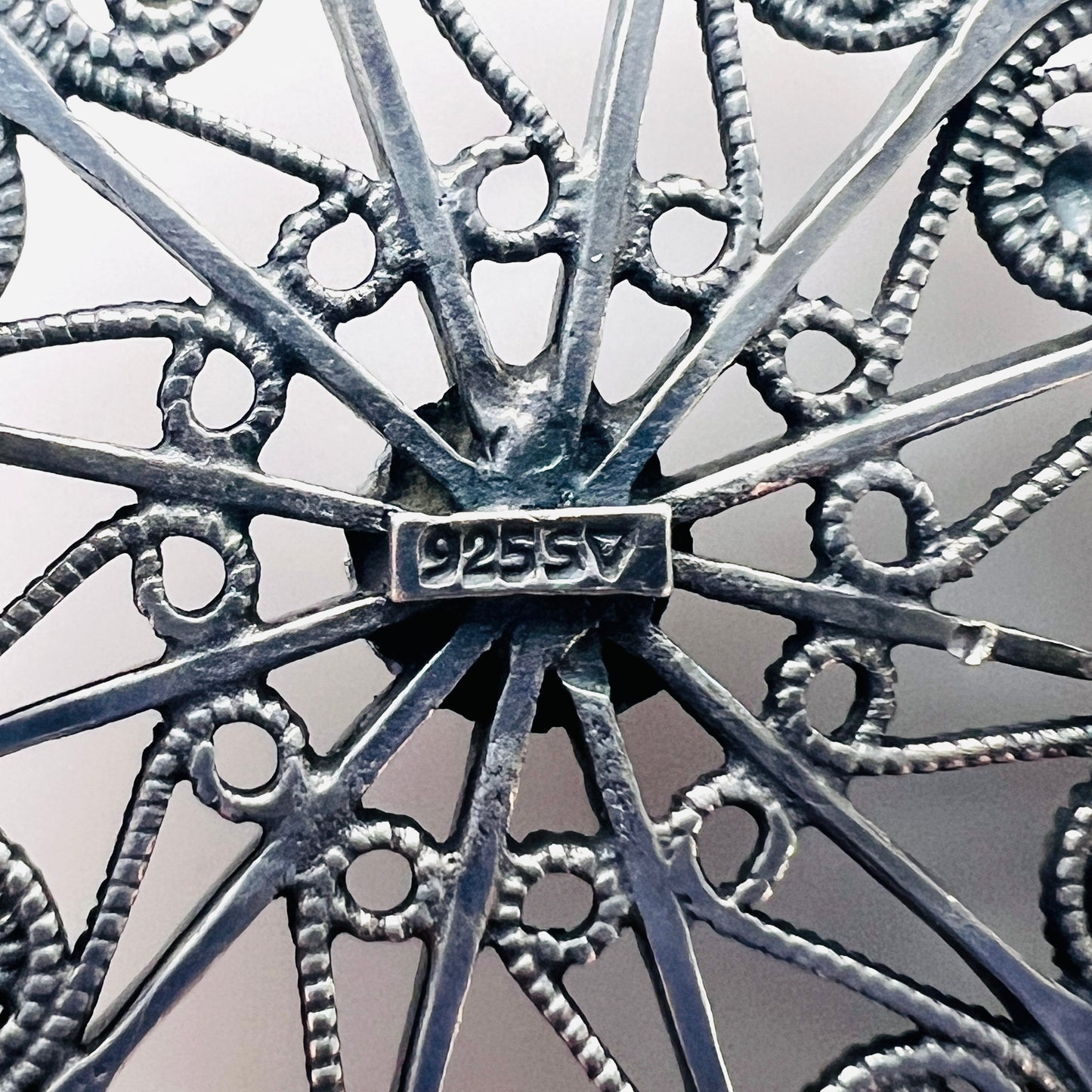 Close-up of 925 SV hallmark on Scandinavian sterling silver brooch.