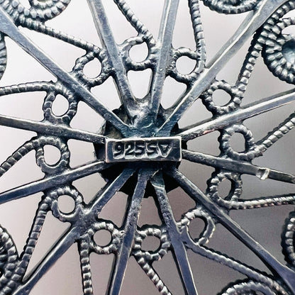 Close-up of 925 SV hallmark on Scandinavian sterling silver brooch.