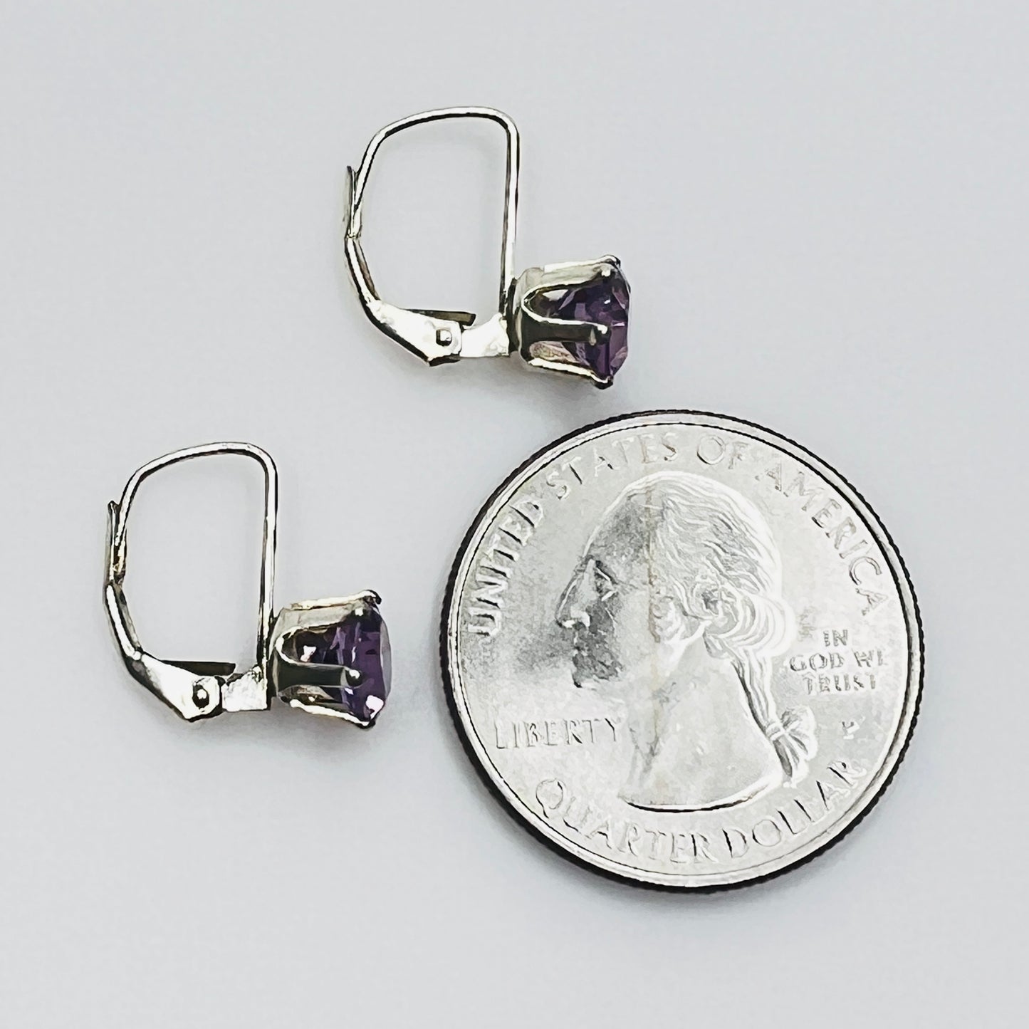 Vintage purple topaz earrings next to coin for size reference