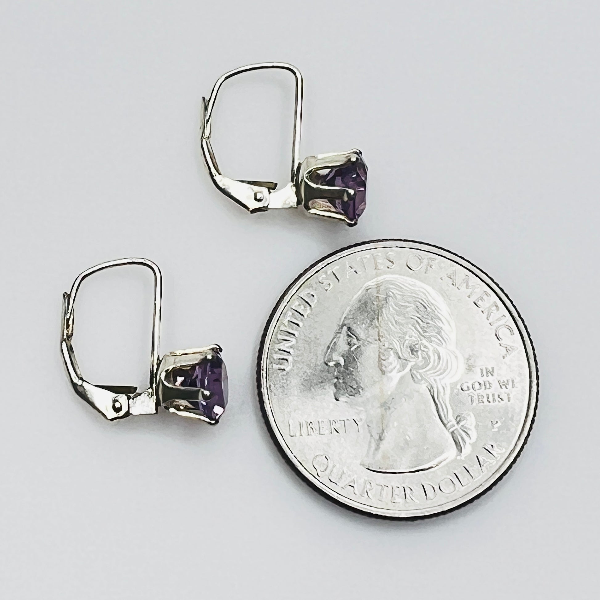 Vintage purple topaz earrings next to coin for size reference