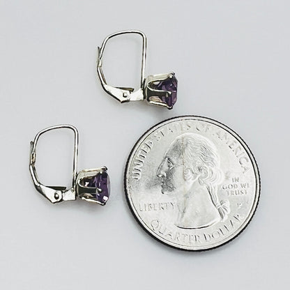 Vintage purple topaz earrings next to coin for size reference