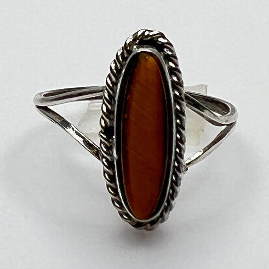 Close-up of elongated tiger’s eye stone with rope bezel