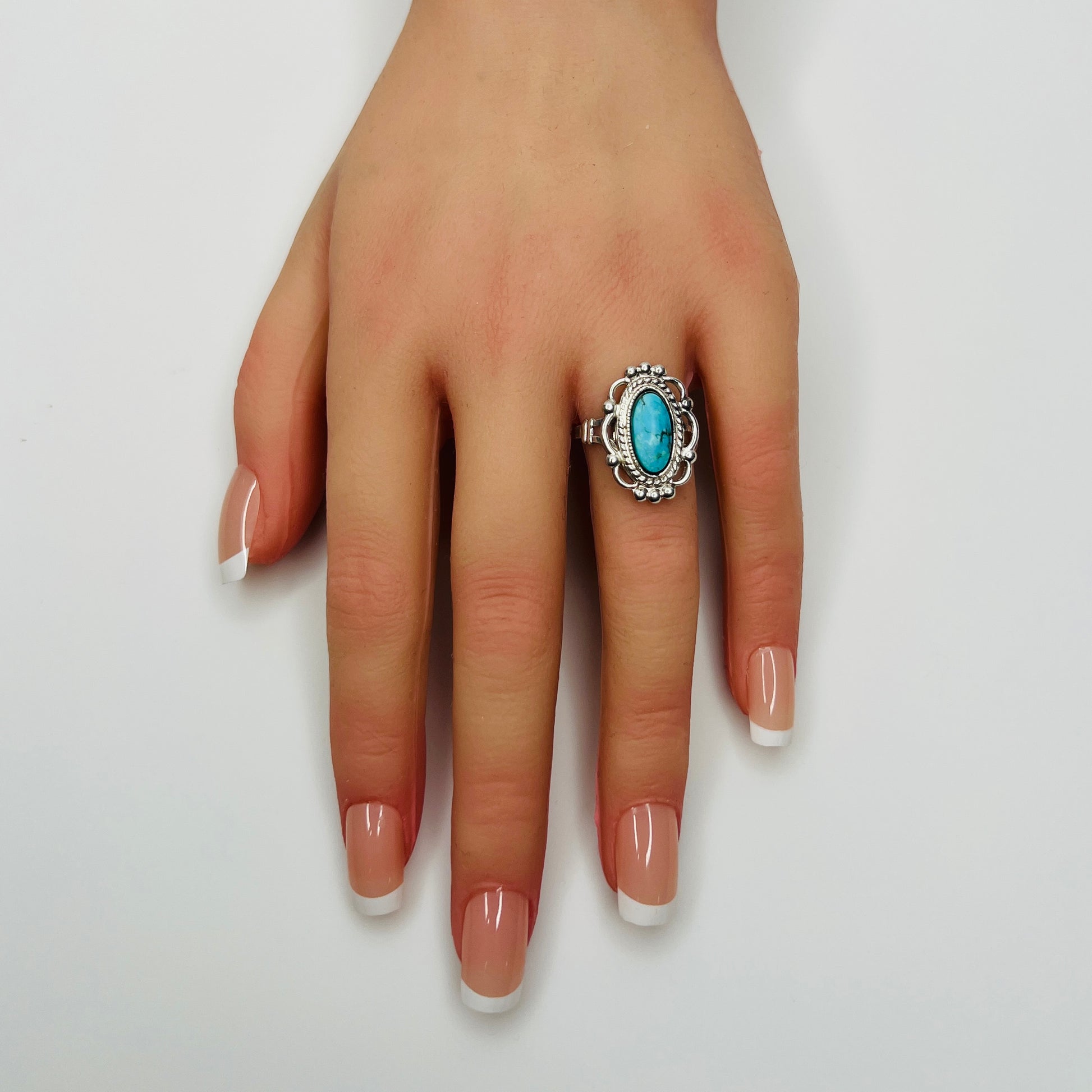 Sterling silver turquoise ring on hand model