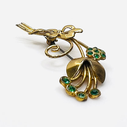 Side view of dimensional vermeil sterling floral brooch with green rhinestones