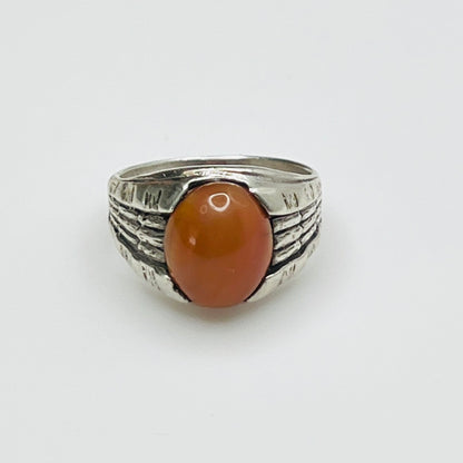 Vintage sterling silver ring with oval orange Yemeni carnelian cabochon and textured shoulders