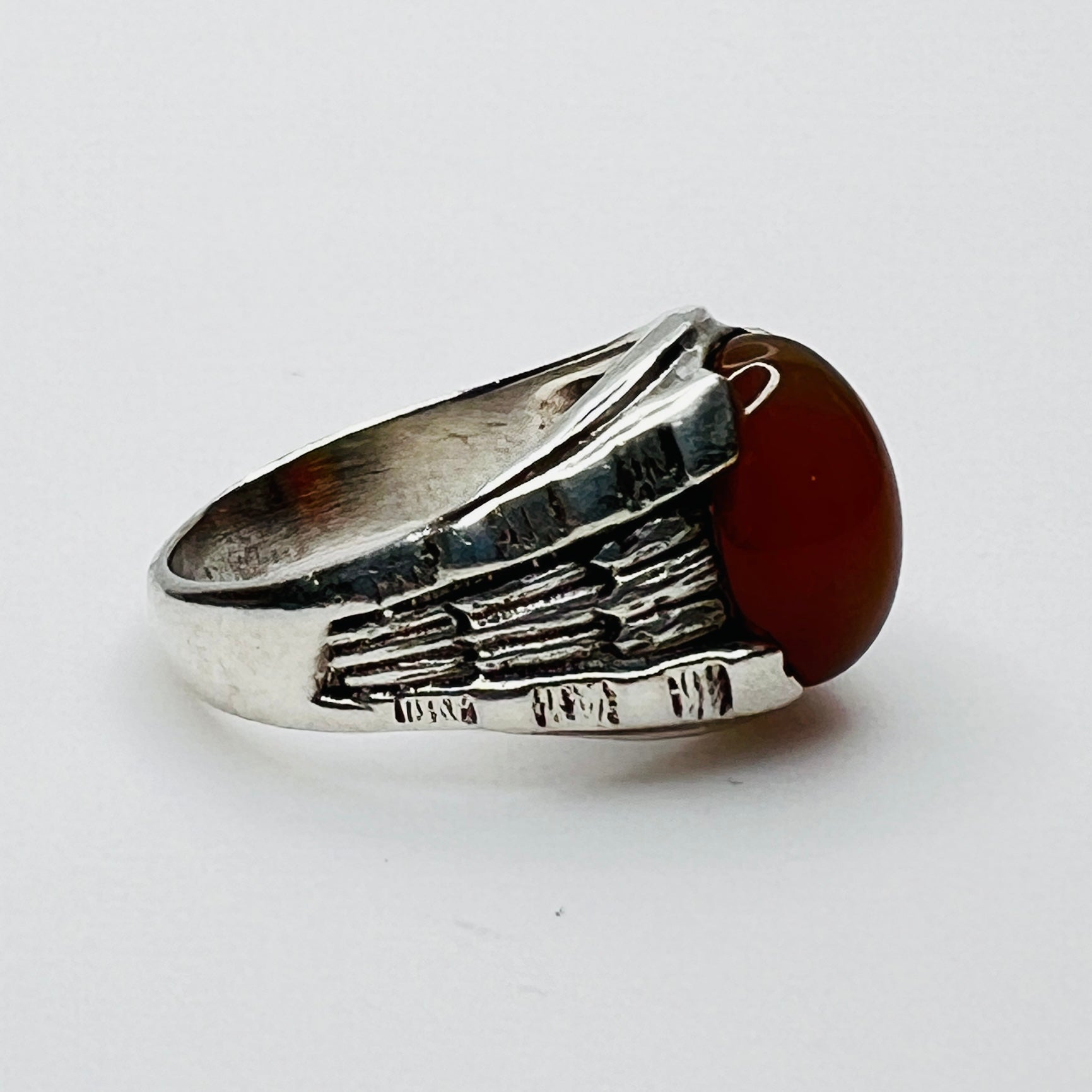 Side view of vintage sterling silver ring with orange carnelian cabochon 