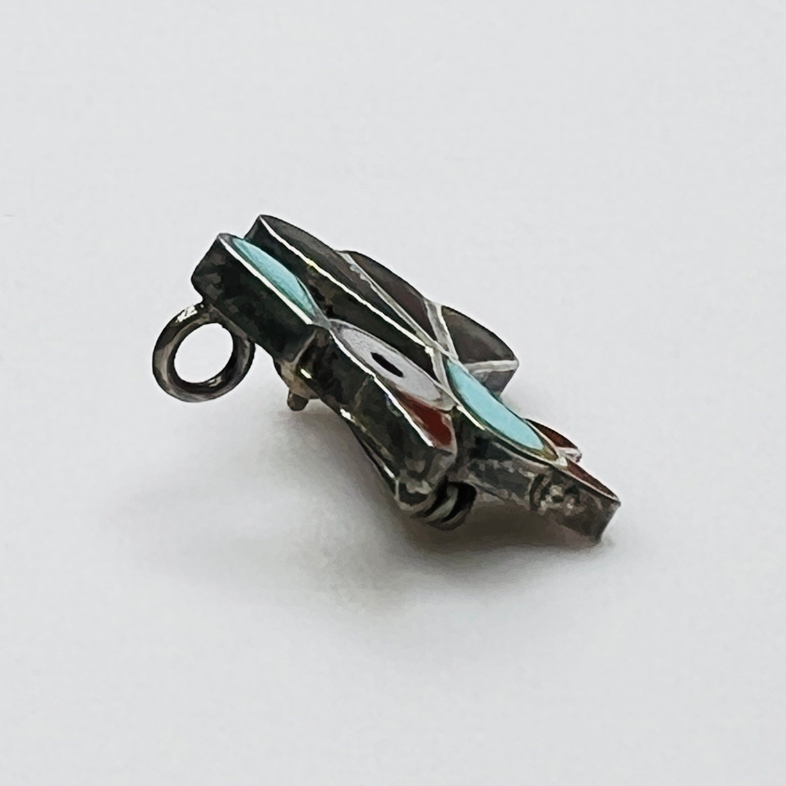 Side profile of vintage sterling silver bird brooch pendant showing inlay construction and pendant loop