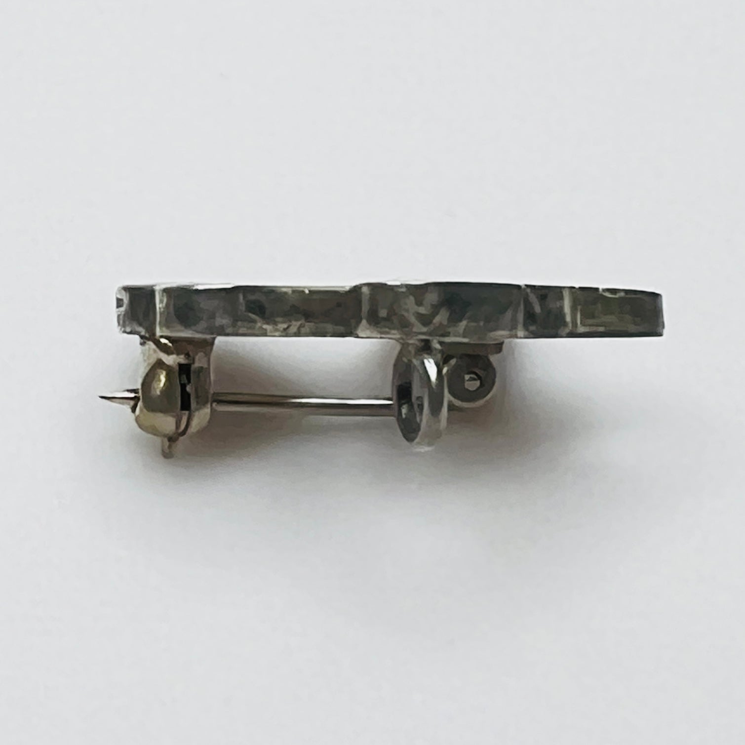 Side profile of vintage sterling silver bird brooch pendant showing inlay construction and pendant loop