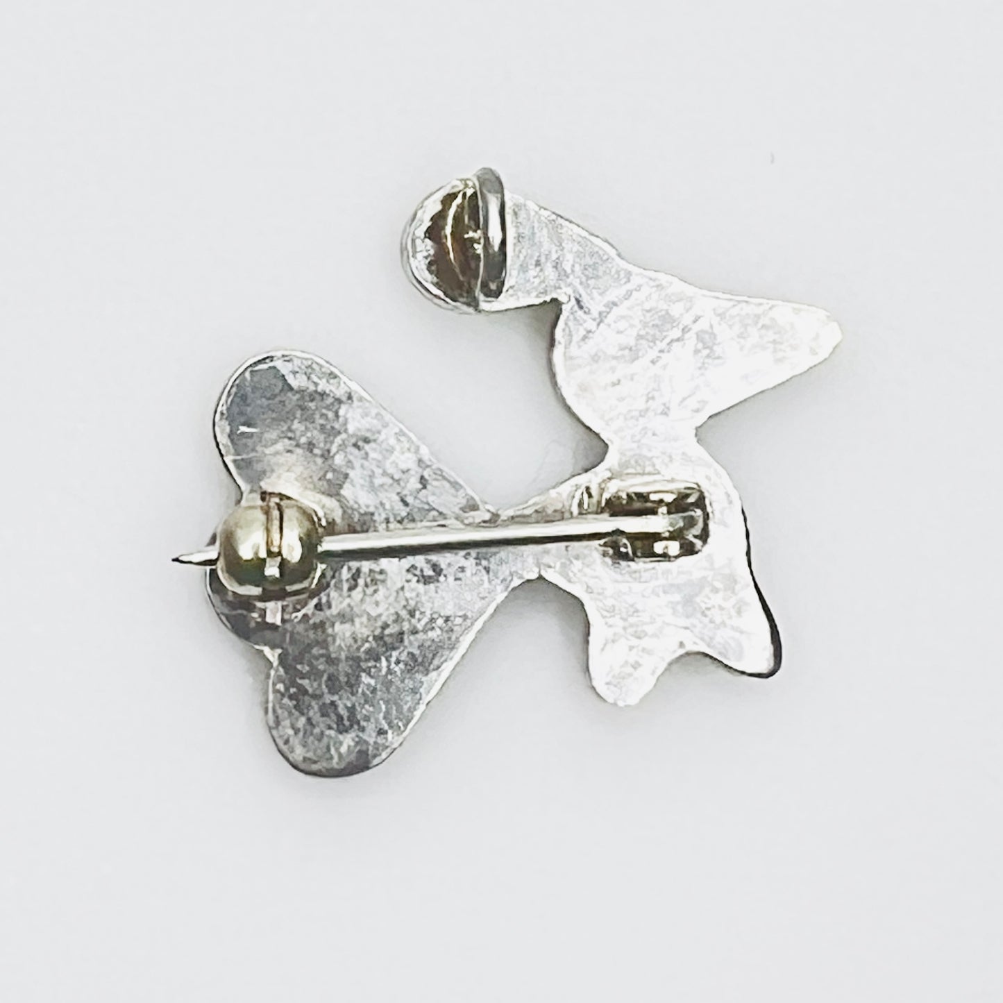 Back of sterling silver bird brooch pendant showing rollover clasp and pendant bail