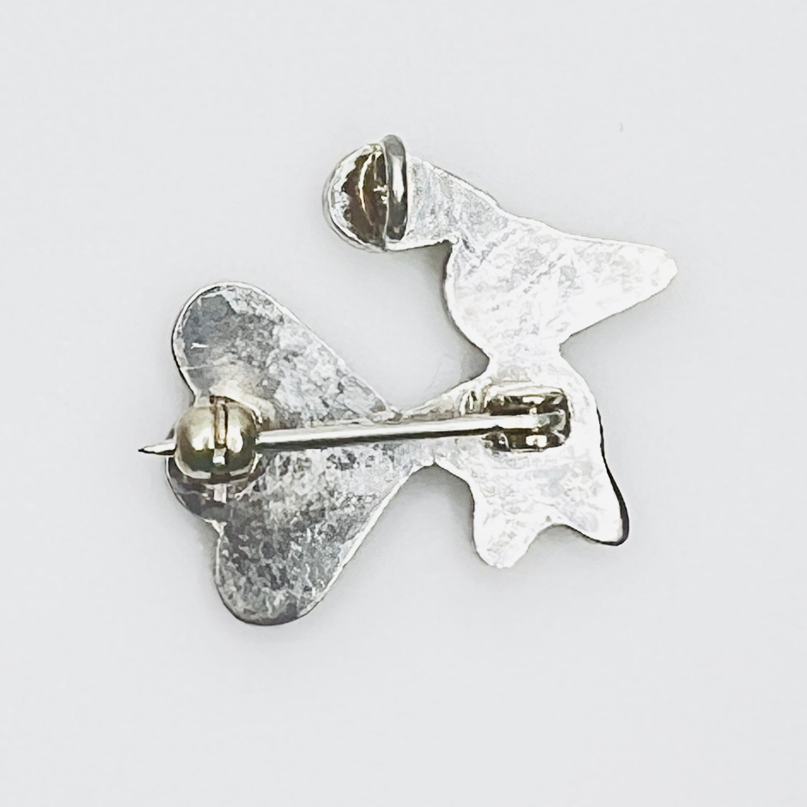 Back of sterling silver bird brooch pendant showing rollover clasp and pendant bail