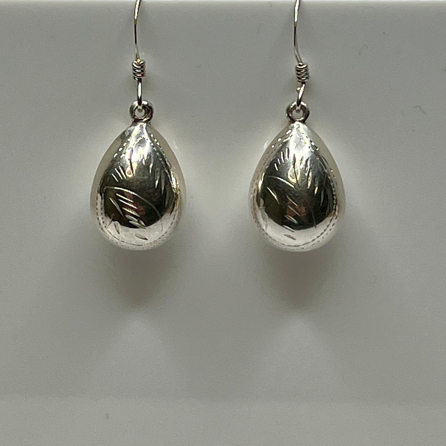 Sterling silver puff teardrop earrings with etched leaf design