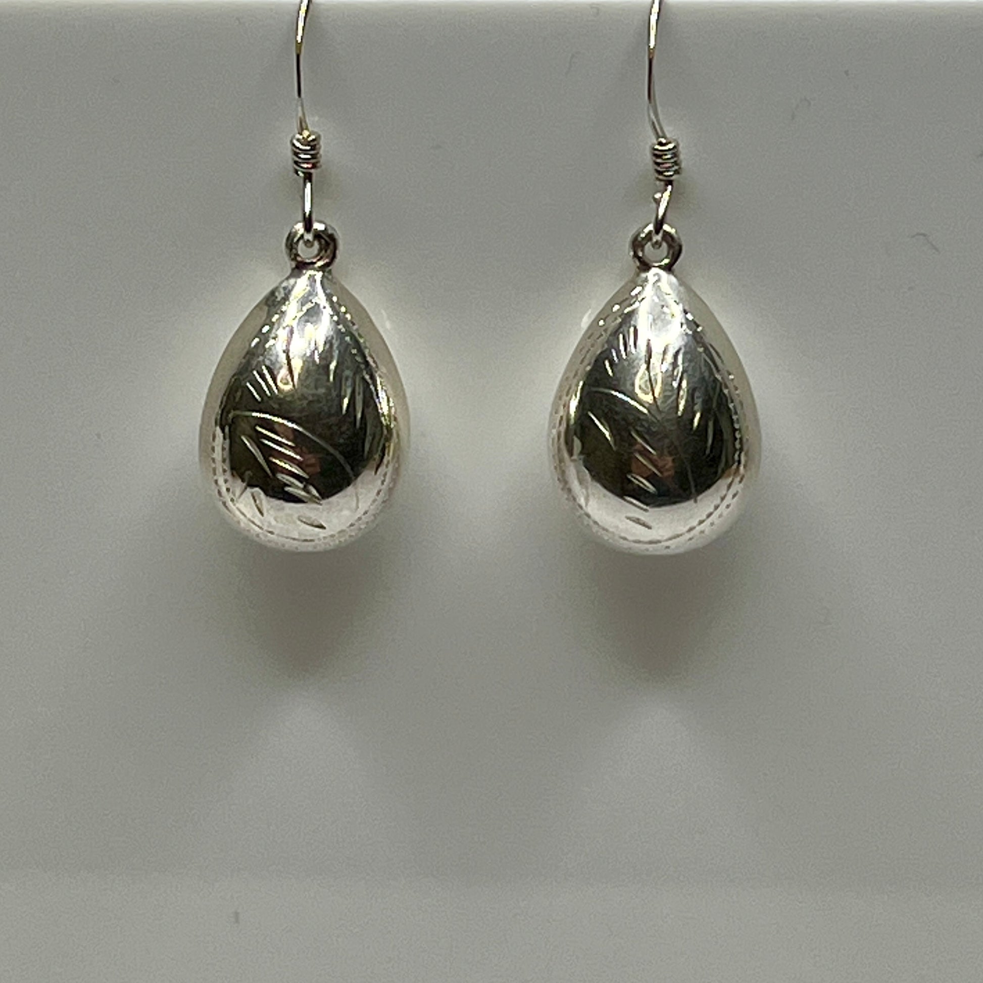 Sterling silver puff teardrop earrings with etched leaf design