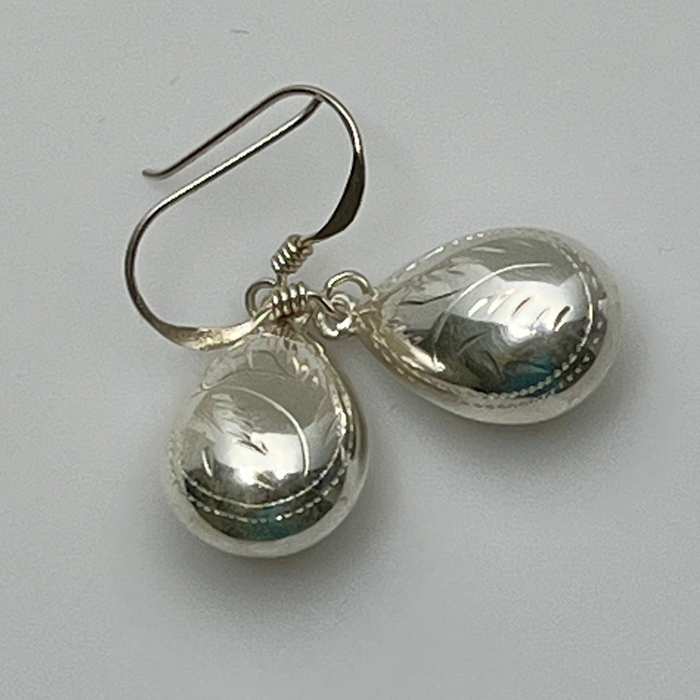 Sterling silver puff teardrop earrings with etched leaf design