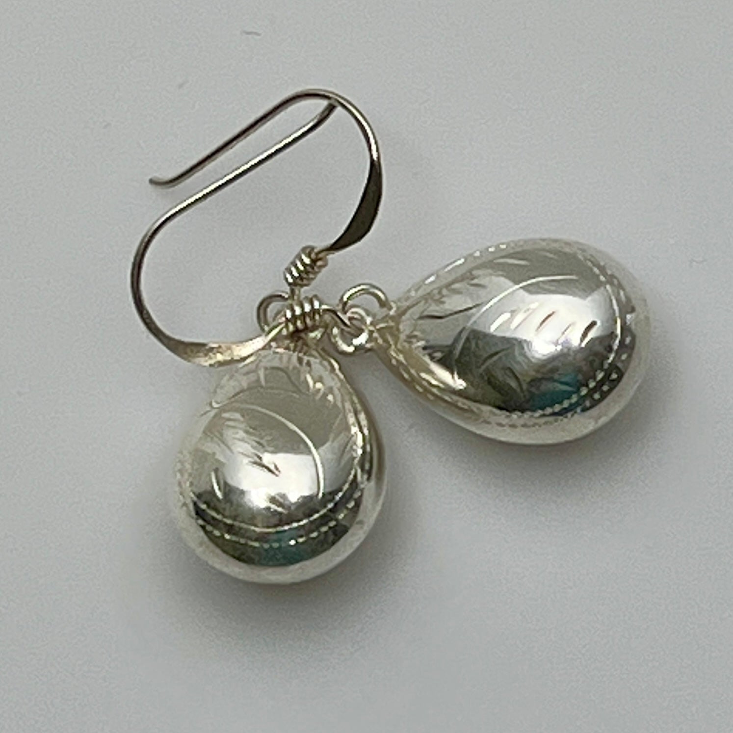 Sterling silver puff teardrop earrings with etched leaf design