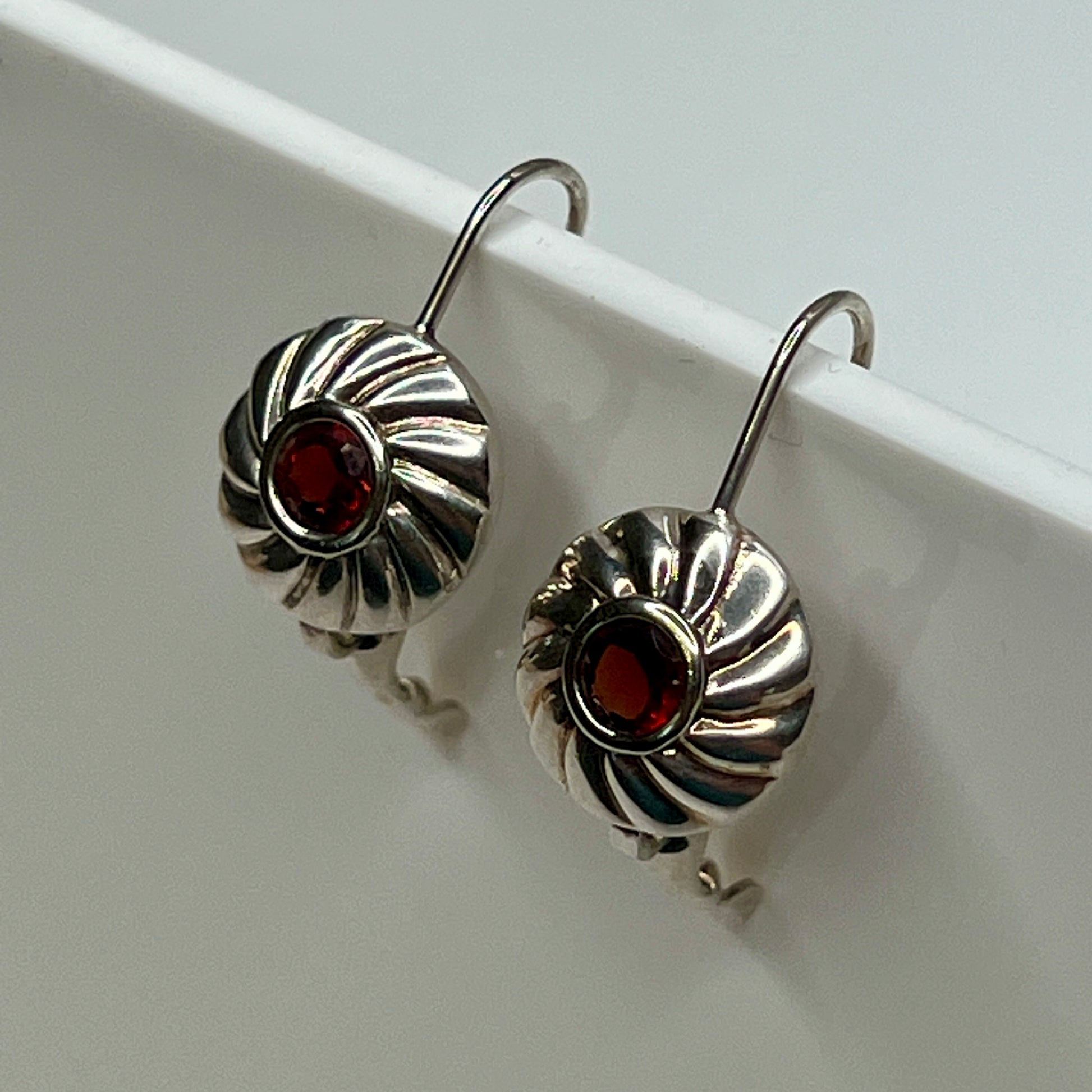 Sterling silver leverback earrings with red spinel cabochons in swirl design