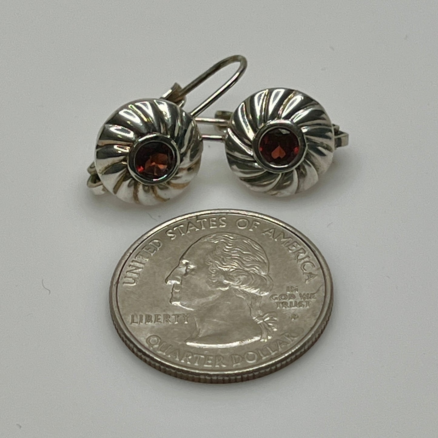 Sterling silver leverback earrings with red spinel cabochons in swirl design
