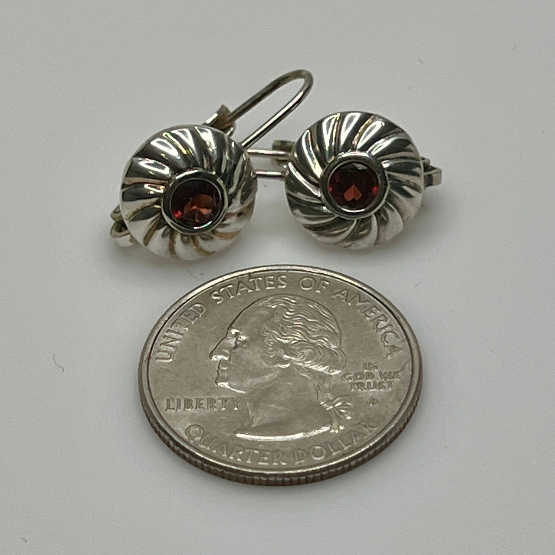 Sterling silver leverback earrings with red spinel cabochons in swirl design